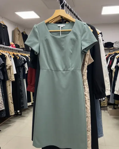 Boutique, before: green dress on a crowded rack
